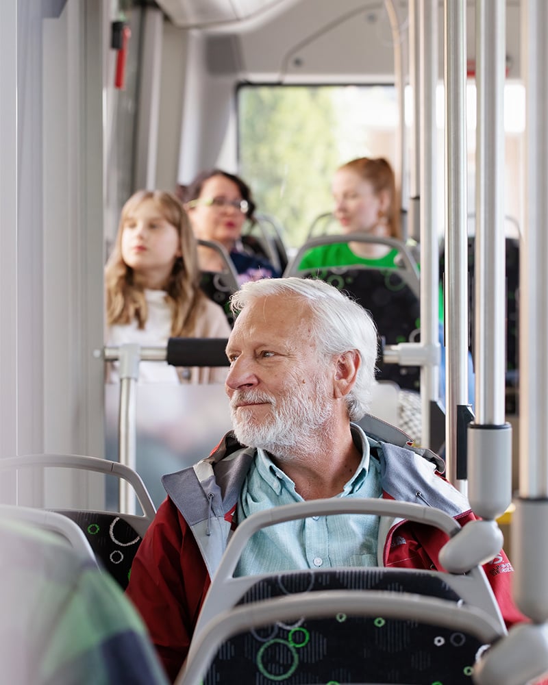 Henkilö istuu bussissa.